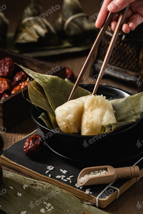 Preview: A Vertical Selective Focus Shot Of Preparation Of Rice Dumplings With Banana Leaves