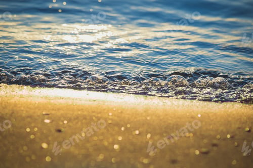 Preview: The Clear Water Of Small Sea Waves On The Sand Sparkling In The Sunshine