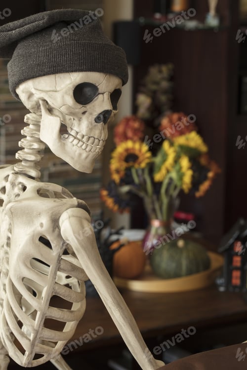 Preview: Halloween Skeleton Sitting On A Sofa And Showing His Holiday Decor