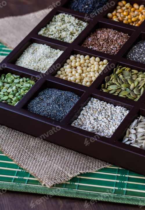 Preview: A Close Up Of A Wooden Box Filled With Compartments Of Seeds And Grains.