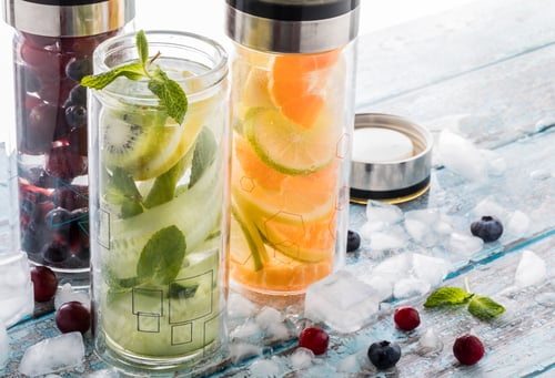 Preview: Three Bottles Filled With Fresh Fruit And Vegetable Infused Water.