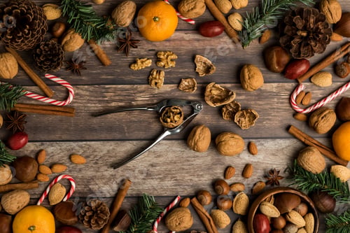 Preview: A Flat Lay View Of A Variety Of Mixed Nuts Along With Oranges, Candy Canes, Cinnamon Sticks And