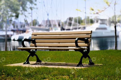 Preview: Wooden Park Bench Beside A Marina With Boats In The Background