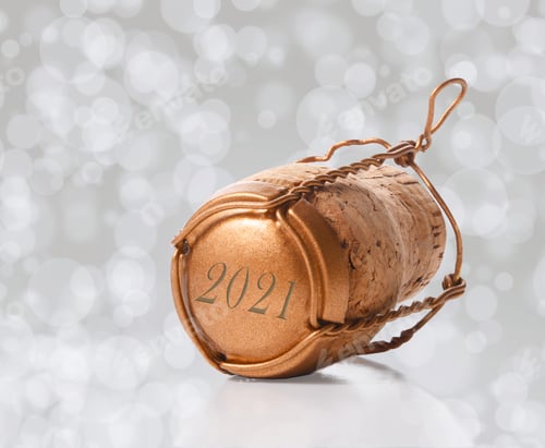 Preview: Closeup Of A Champagne Cork And Cage Dated 2021 Laying On Is Side On A Bokeh Background.