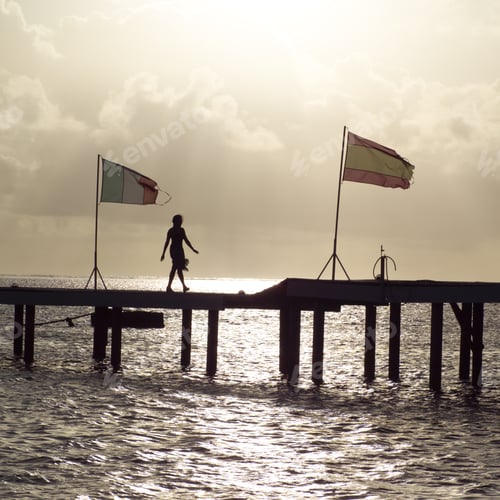 Preview: Silhouette Of Woman Walking Along Pier At Moorea In Tahiti