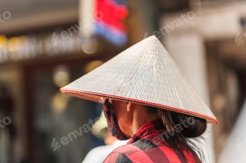 Preview: Woman Wearing A Traditional Woven Rice Hat On The Streets Of Hanoi, Vietnam.