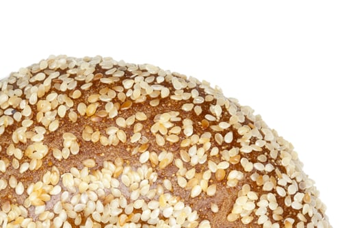 Preview: Cropped Image Bagel With Sesame Seeds Against White Background