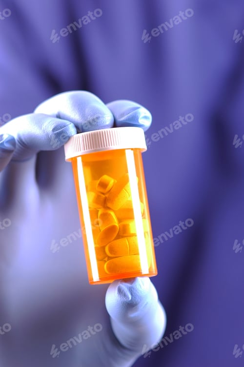 Preview: Gloved Hand Holding Prescription Medicine Bottle With Selective Focus