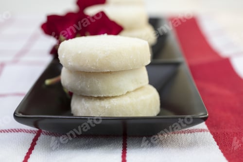 Preview: Lemon Cookies Stacked And Plated On A Red And White Table Cloth With And Strawberry Embroidery And