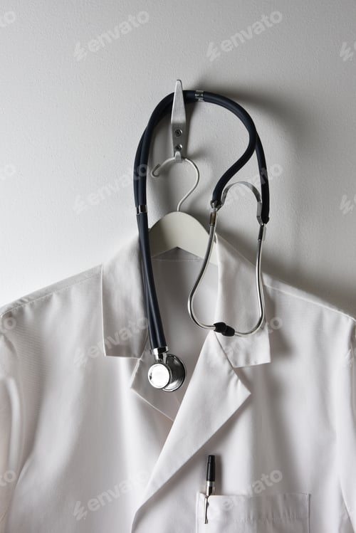 Preview: Medical Coat with Stethoscope Hanging on Wall