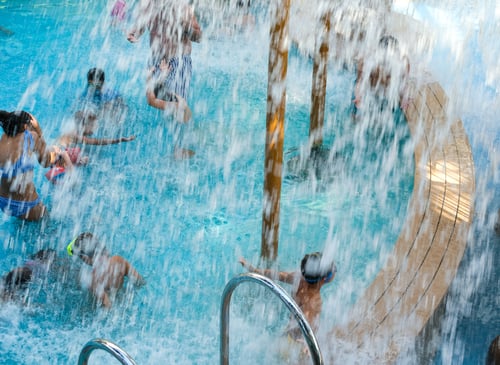 Preview: People Splashing In Pool While Water Pouring On Them From Above