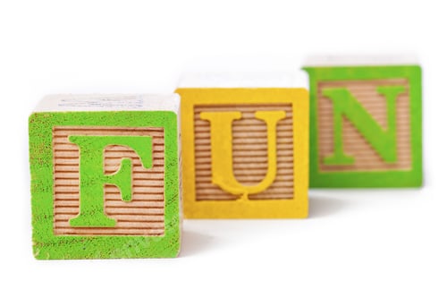 Preview: Close-Up Shot Of Playing Cubes Arranged In Order To Form A Word Fun Over Plain White Background.