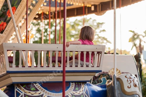 Preview: Child On A Carousel At A Carnival Or Festival At Sunset. Decorative Ornate Elephant, Animals At An