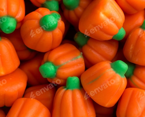 Preview: Top Close View Of Orange And Green Halloween Pumpkin Candy Illuminated With Natural Light.