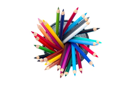 Preview: A Vivid Array Of Pencil Crayons Standing In A Jar On A White Background.