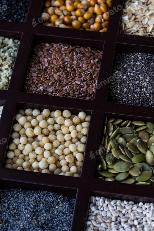 Preview: Angled View Of A Wooden Box With Compartments Of Different Seeds And Grains.
