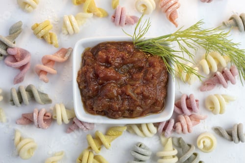 Preview: Curly And Twisted Pasta Shapes On A Cutting Board In Various Colors Of Pink, Yellow, Green And