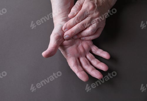 Preview: An Older Man Indicates An Area Of Pain On His Thumb