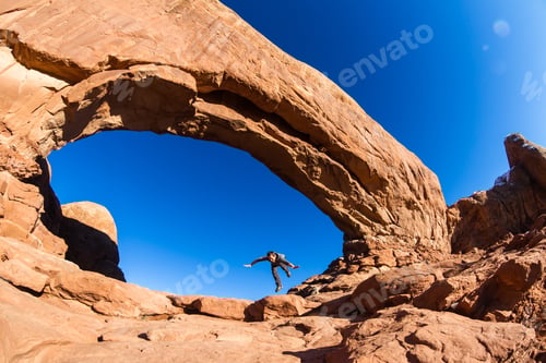 Preview: Man Pretending To Trip And Fall As A Concept To Be Be Careful While Hiking On The Slick Red Rocks