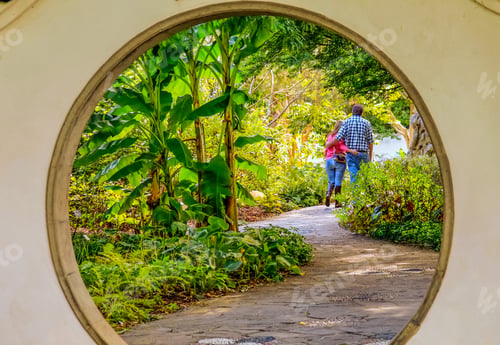 Preview: View Of A Hugging Middle Aged Couple Through A Round Archway