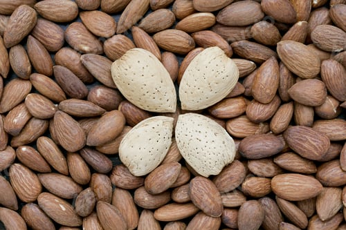 Preview: Close-Up Image Of Almonds With Shell Isolated On A Group Of Almonds