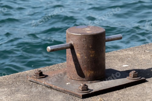 Preview: A Rusty Maritime Ship Mooring Cleat Or Bollard On A Pier By The Waters Edge