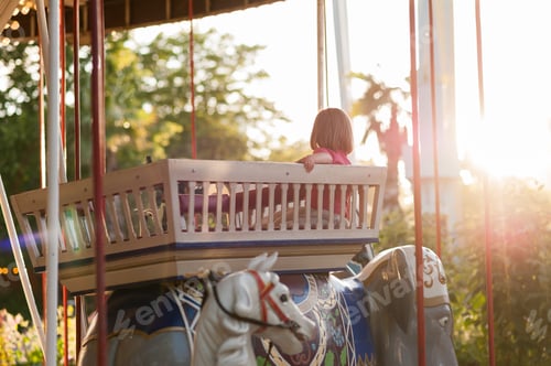 Preview: Child On A Carousel At A Carnival Or Festival At Sunset. Decorative Ornate Elephant, Animals At An