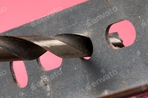 Preview: Extreme Close Up Of An Electric Drill With A High Speed Metal Drill Bit Through A Piece Of Metal