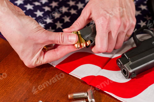 Preview: Female Hands Loading A Hand Gun With Hallow Point Bullets And An American Flag In The Background