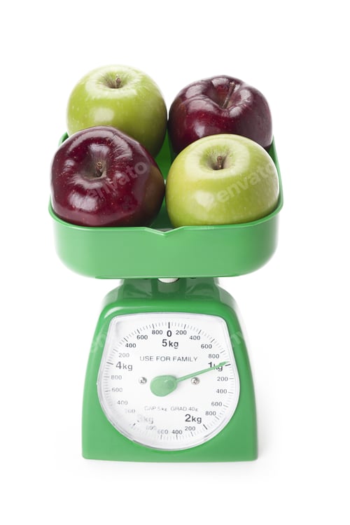 Preview: Apples On A Scale Weight Loss Concept Isolated On A White Background