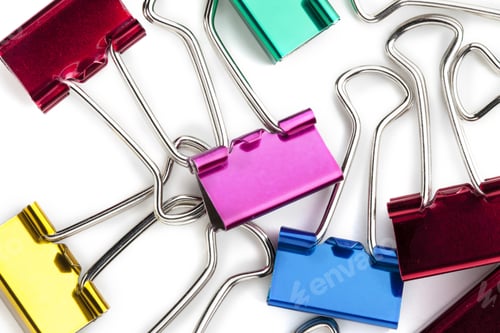 Preview: Assorted Colorful Metal Clips Over The White Background