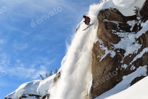 Skier Jumping Off Cliffside Covered in Snow