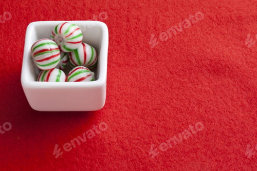 Preview: A Peppermint Bowl Of Candy Isolated On Red
