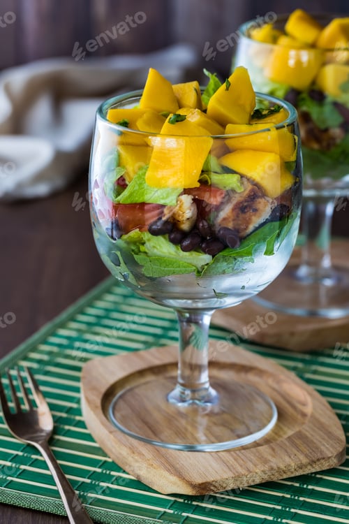Preview: Close Up Front View Of A Chalice Glass Filled With A Caribbean Layered Salad.