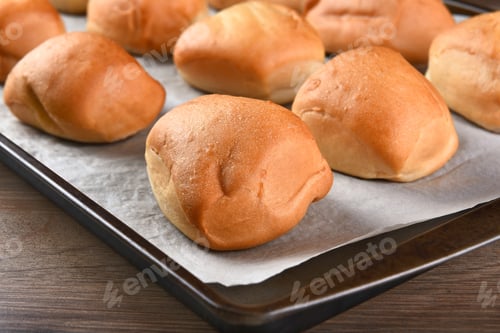Preview: Closeup Of Fresh Baked Dinner Rolls On A Baking Sheet Lined With Parchment Paper. Shallow Depth Of