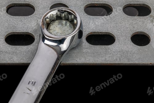 Preview: Closeup Of An Box Wrench On A Bolt Head On A Black Background