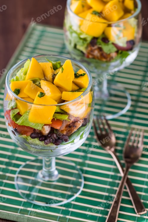 Preview: A Top Down View Of A Layered Tropical Salad In A Chalice Glass.