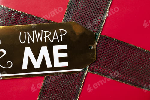 Preview: Christmas Wrap Gift Present Background Closeup Detail With The Word Unwrap Me