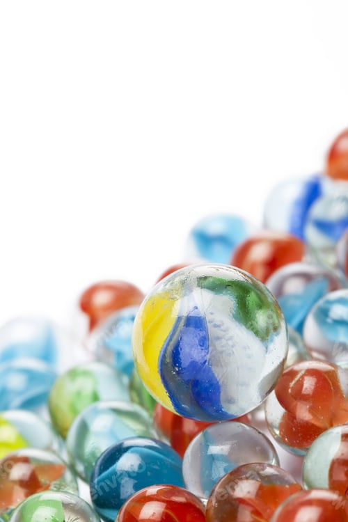 Preview: Closed Up Shot Of Assorted Toy Marbles Over A White Background