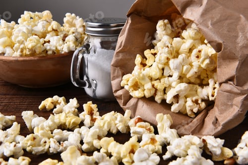Preview: Closeup Of A Bag Of Fresh Popped Homemade Popcorn With A Bowl And Salt Shaker.