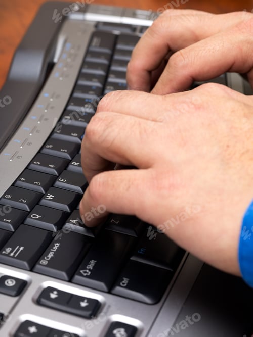 Preview: Close-Up Cropped Image Of Human Hands Typing On Black Keyboard.