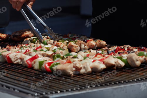 Preview: Barbecue Chicken Kabobs Being Grilled At An Amusement Park