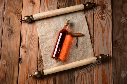 Preview: Bottle Of Wine And Corkscrew Laying On A Scroll Of Parchment Paper On A Wooden Floor.