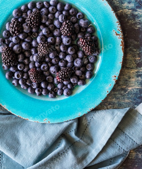Preview: Bright Blue Plate Of Blueberries And Blackberries Ready For Eating.