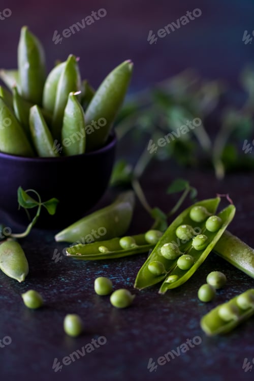 Preview: Close Up View Of Snap Pea Pods Against A Dark Background.