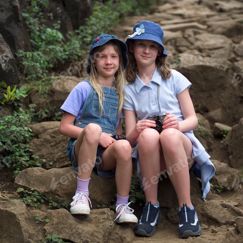Preview: "Stock - Portrait Of Two Young Girls Sitting On Rocks, Kauai, Molokai, Hawaii, February 2004 (Keith