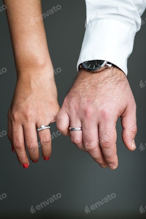 Preview: Close Up Of The Hands Of A Couple Wearing Their Wedding Bands