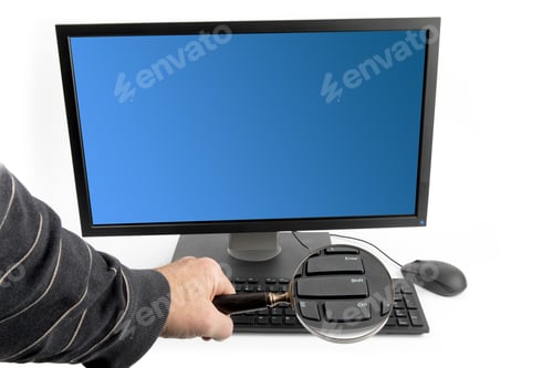 Preview: Computer Security - A Man Scanning A Computer Keyboard Through A Magnifying Glass Signifying A