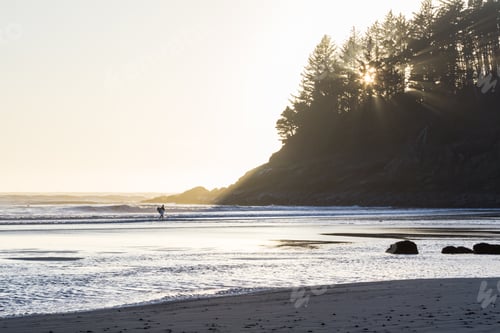 Preview: Person Surfing In Hunters Cover With The Sunsetting In The Background Adding A Glow To The Wind