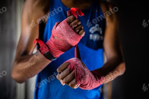 Preview: Boxer Wrapping Hands With Red Hand Wraps Before Fight
